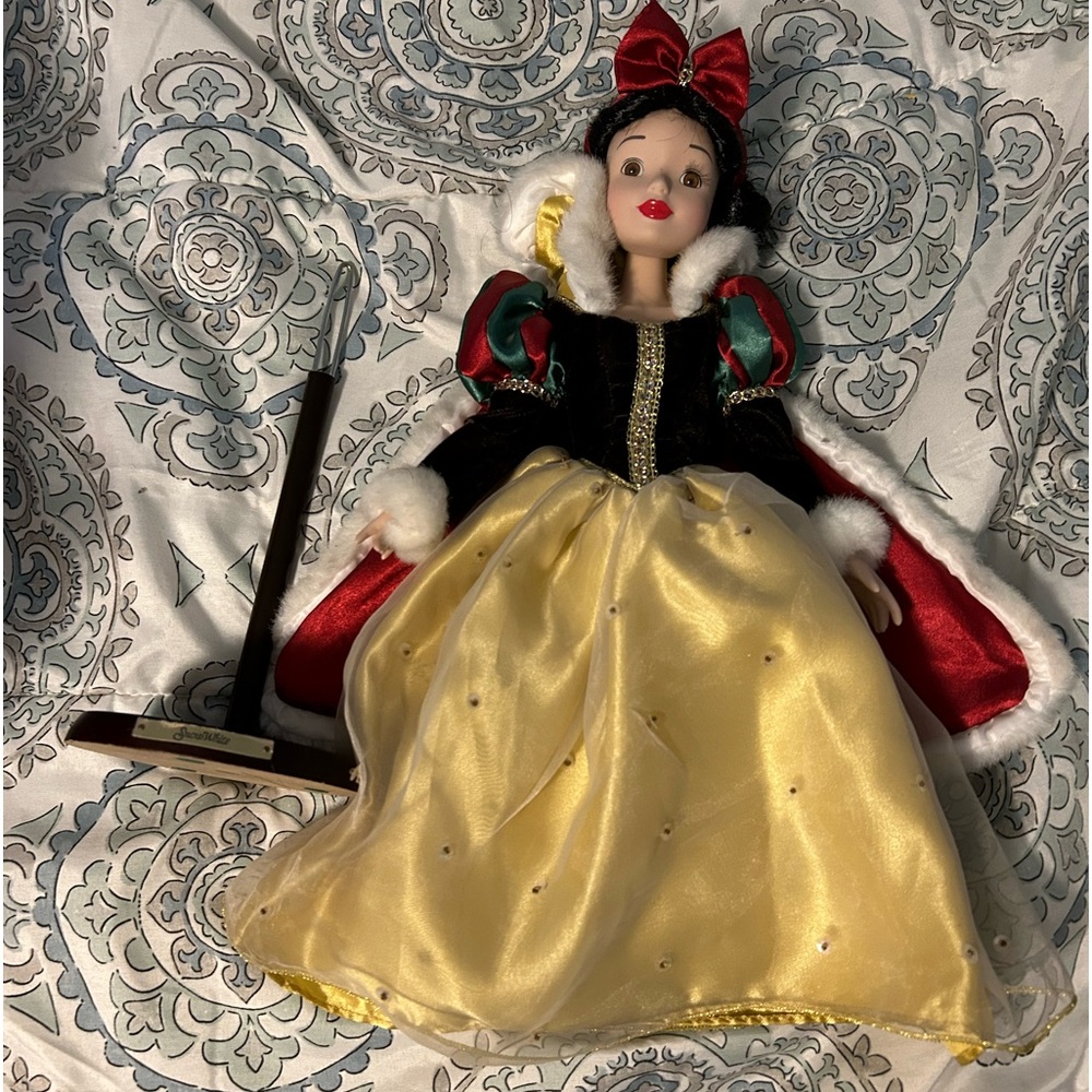 Porcelin Snow White doll on stand.